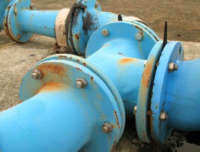 Large blue rusty pipes that are connected